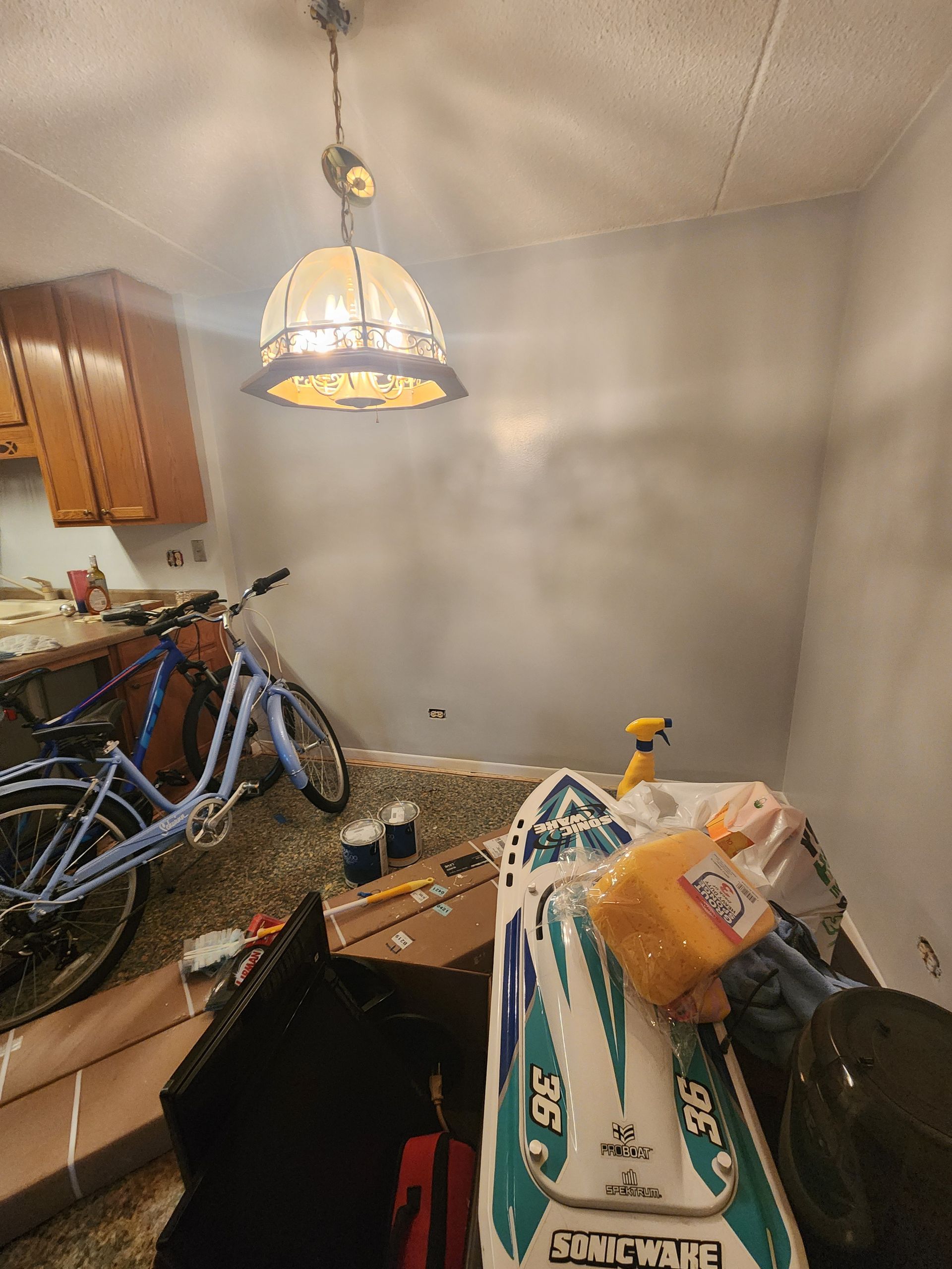 A room with a bicycle and a boat in it