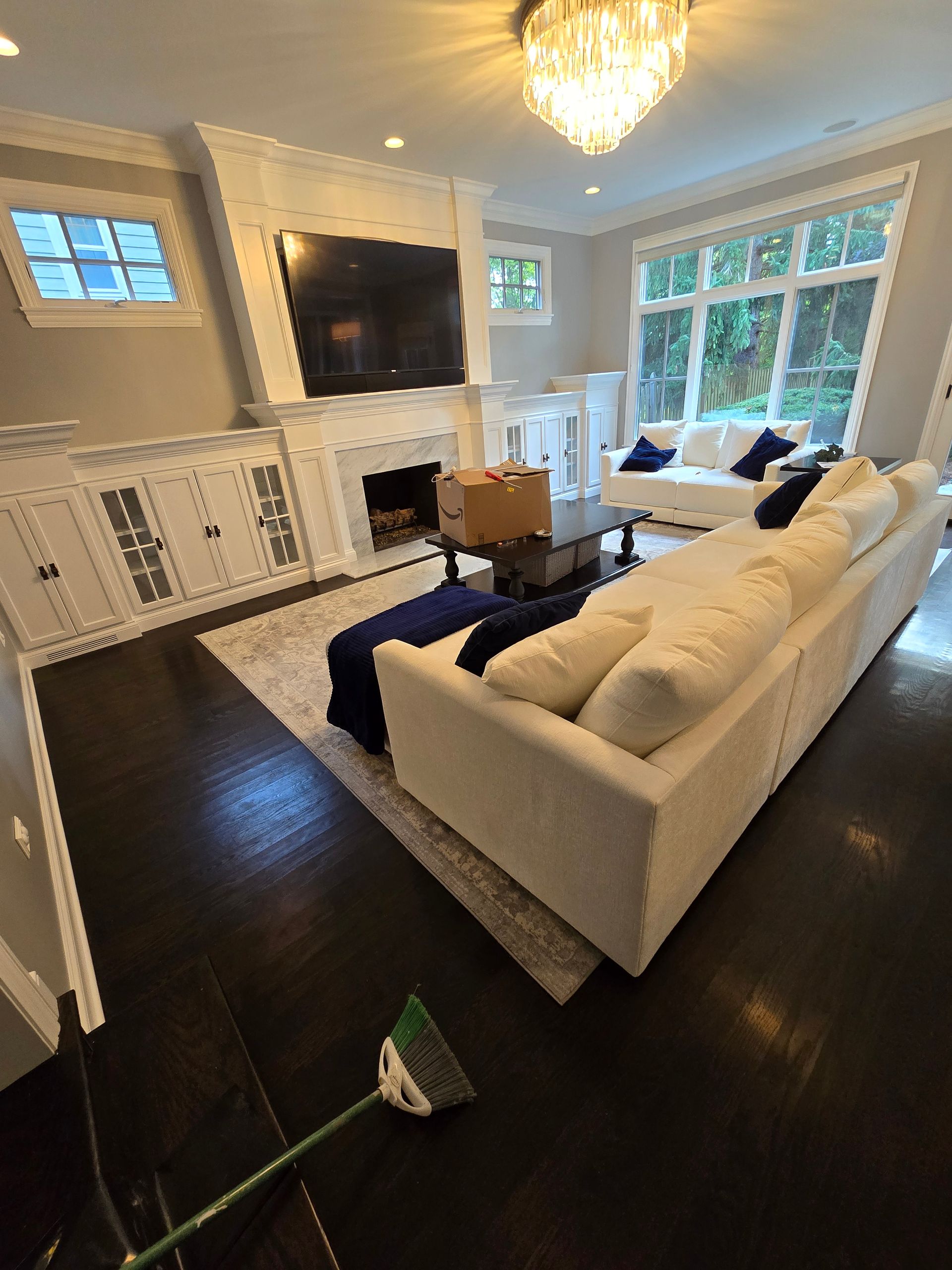A living room with a couch , fireplace and television.