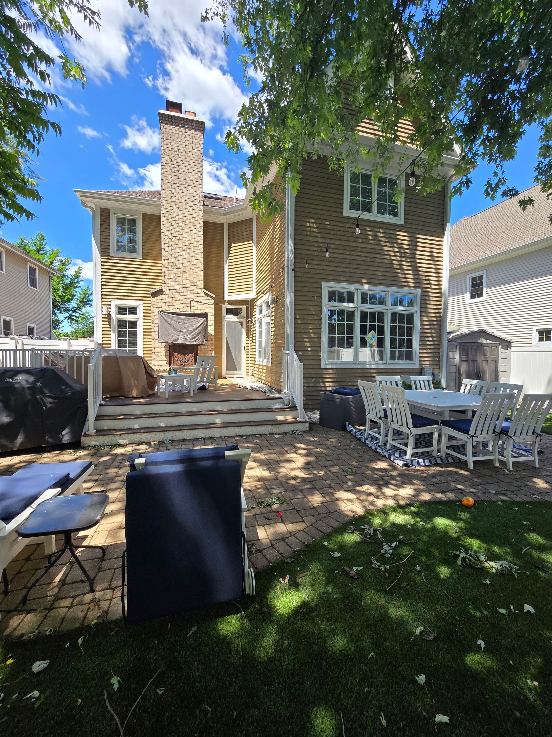 The backyard of a house with a table and chairs