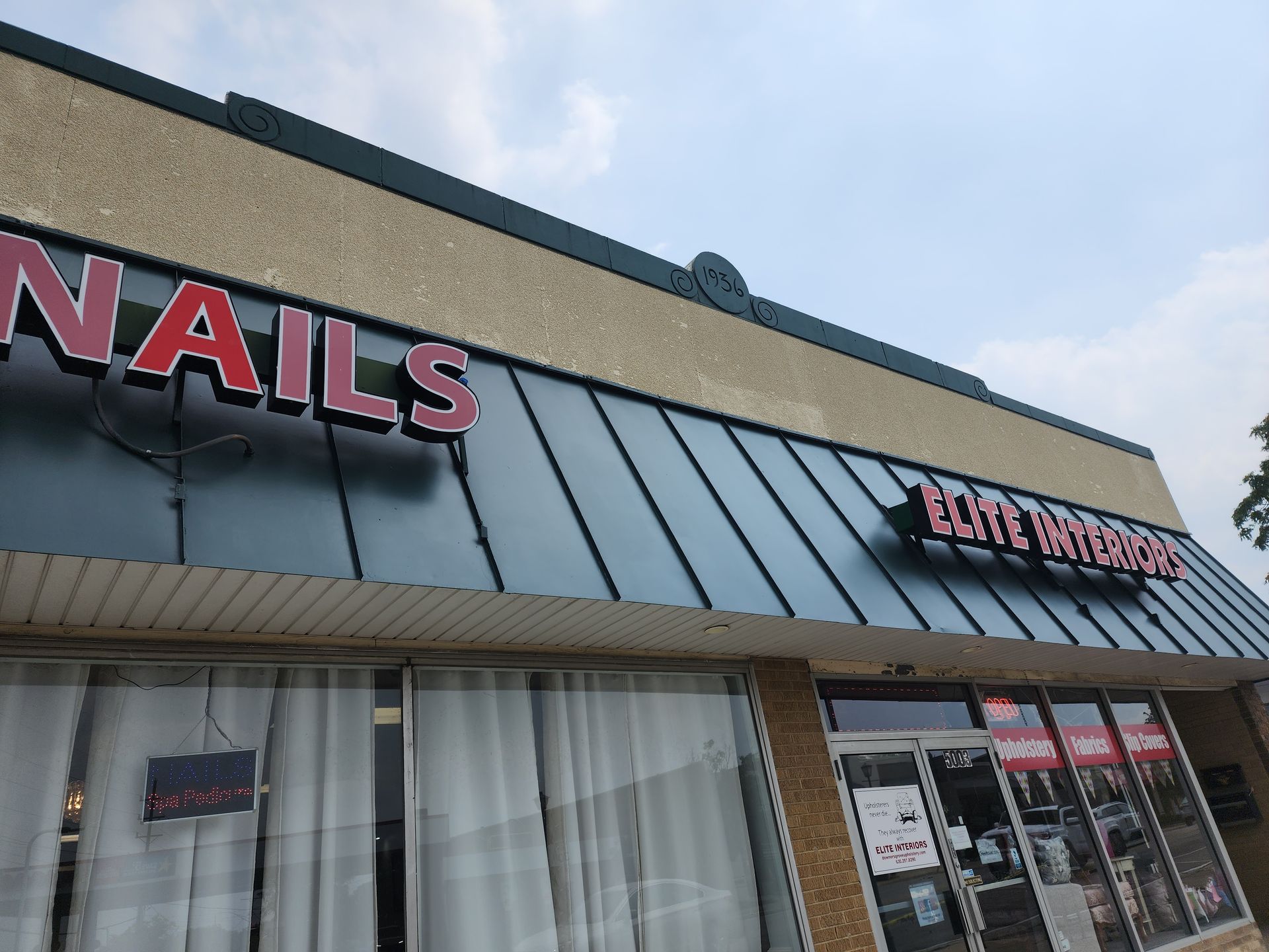 A building with a sign that says nails on it