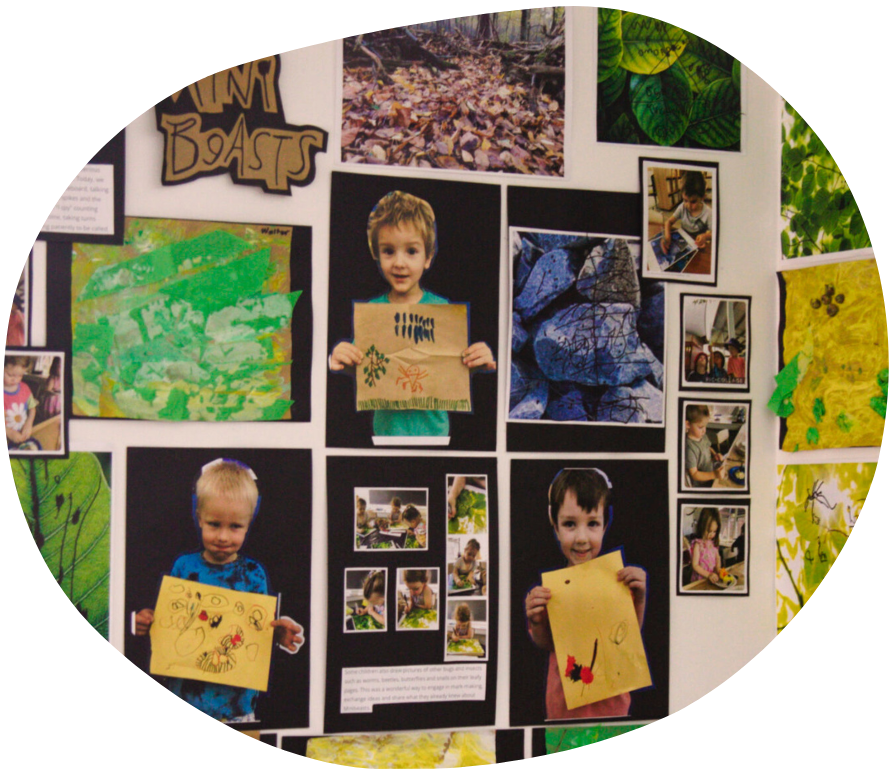 Children's artwork and photos on a wall. Includes art, pictures of the kids, and nature images.