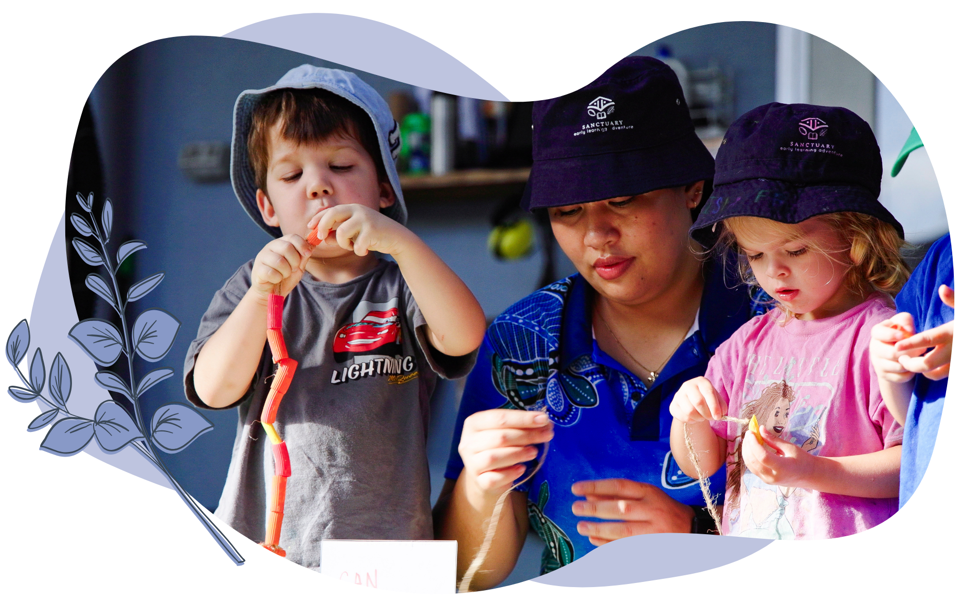 Children and adult stringing candy with smiling expressions, outdoors.