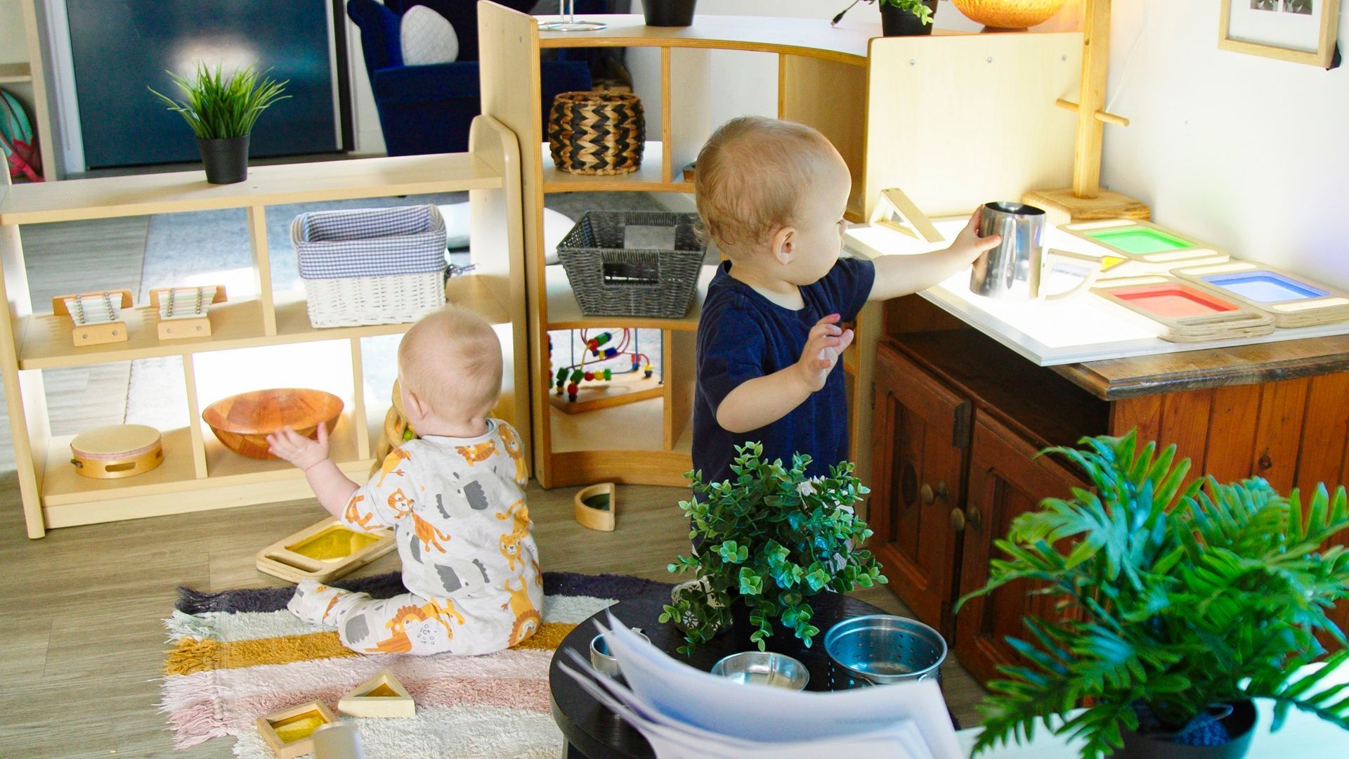 two babies playing side by side in a childcare setting