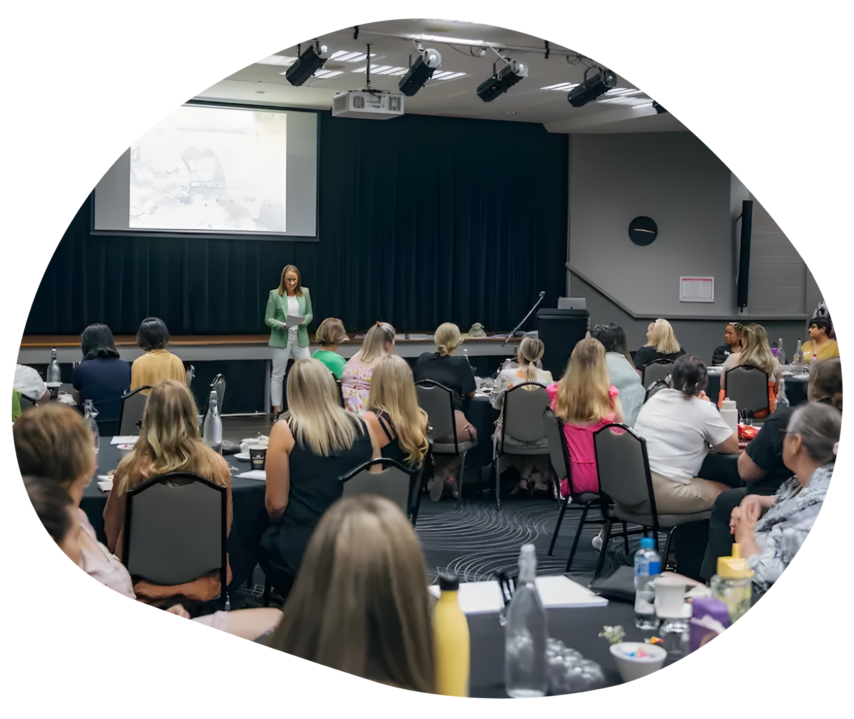 Child laughing while someone holds their foot, another child watches.
