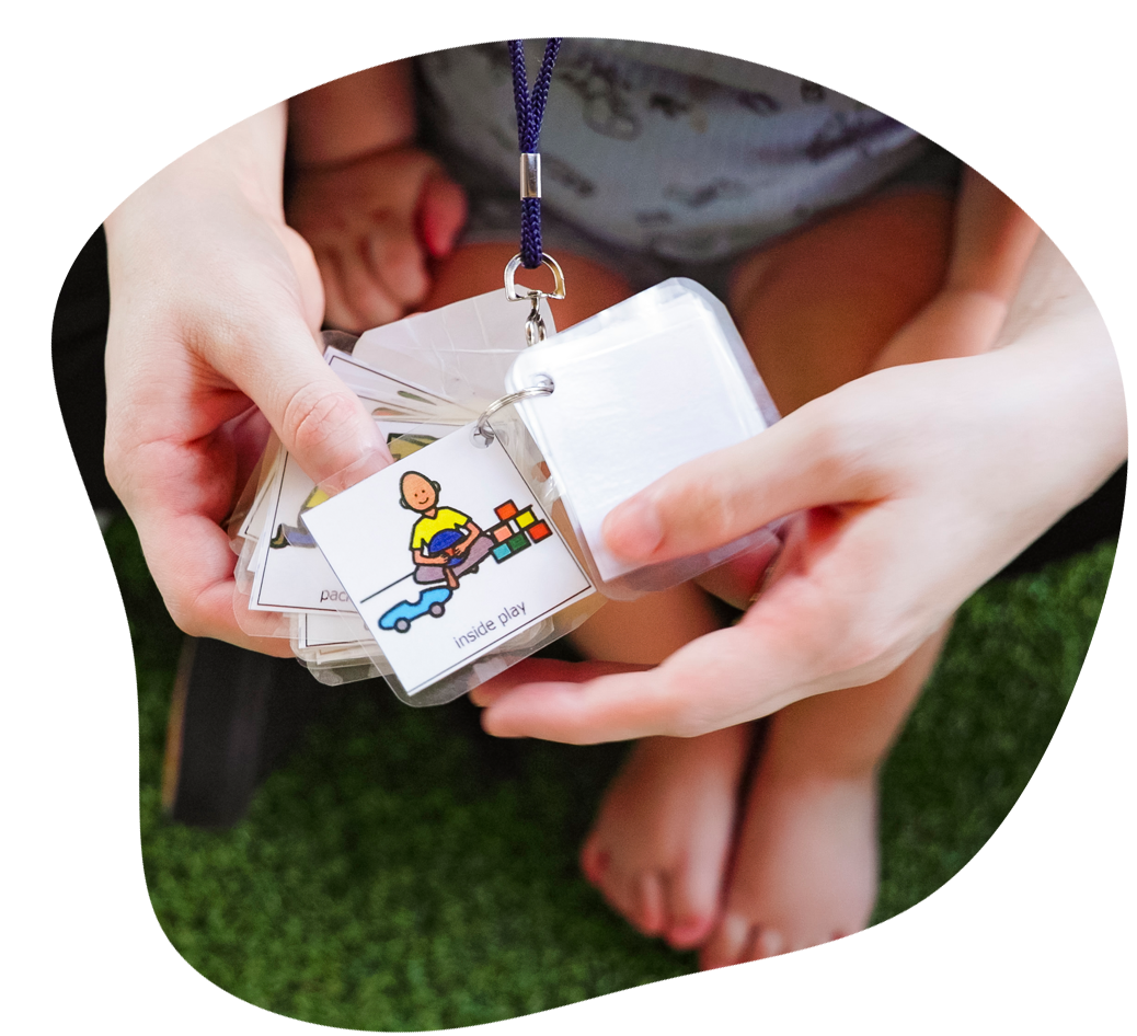 Smiling child in striped shirt and blue shorts, running in a colorful indoor playspace.