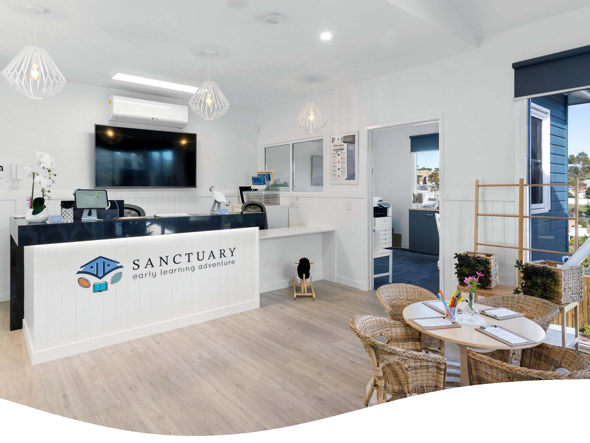 Reception area with white walls, desk with