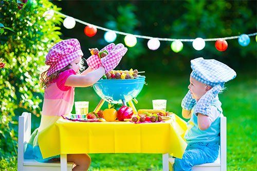 Siblings Playing With Their Food Toys