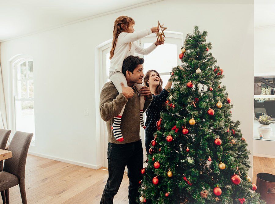 Happy Family Decorating the Christmas Tree — Reno, NV — All American Storage