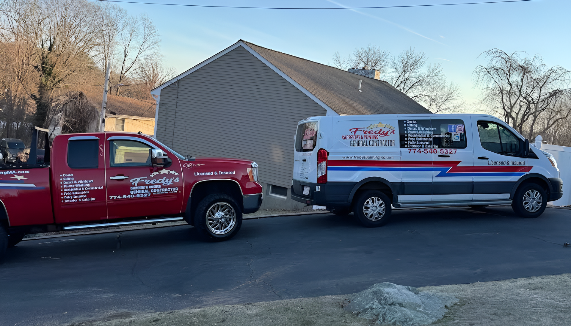 Red pickup truck towing a white service van, parked in front of a house on a sunny day.