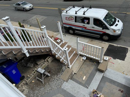 Collapsed porch steps with debris; service van parked nearby.