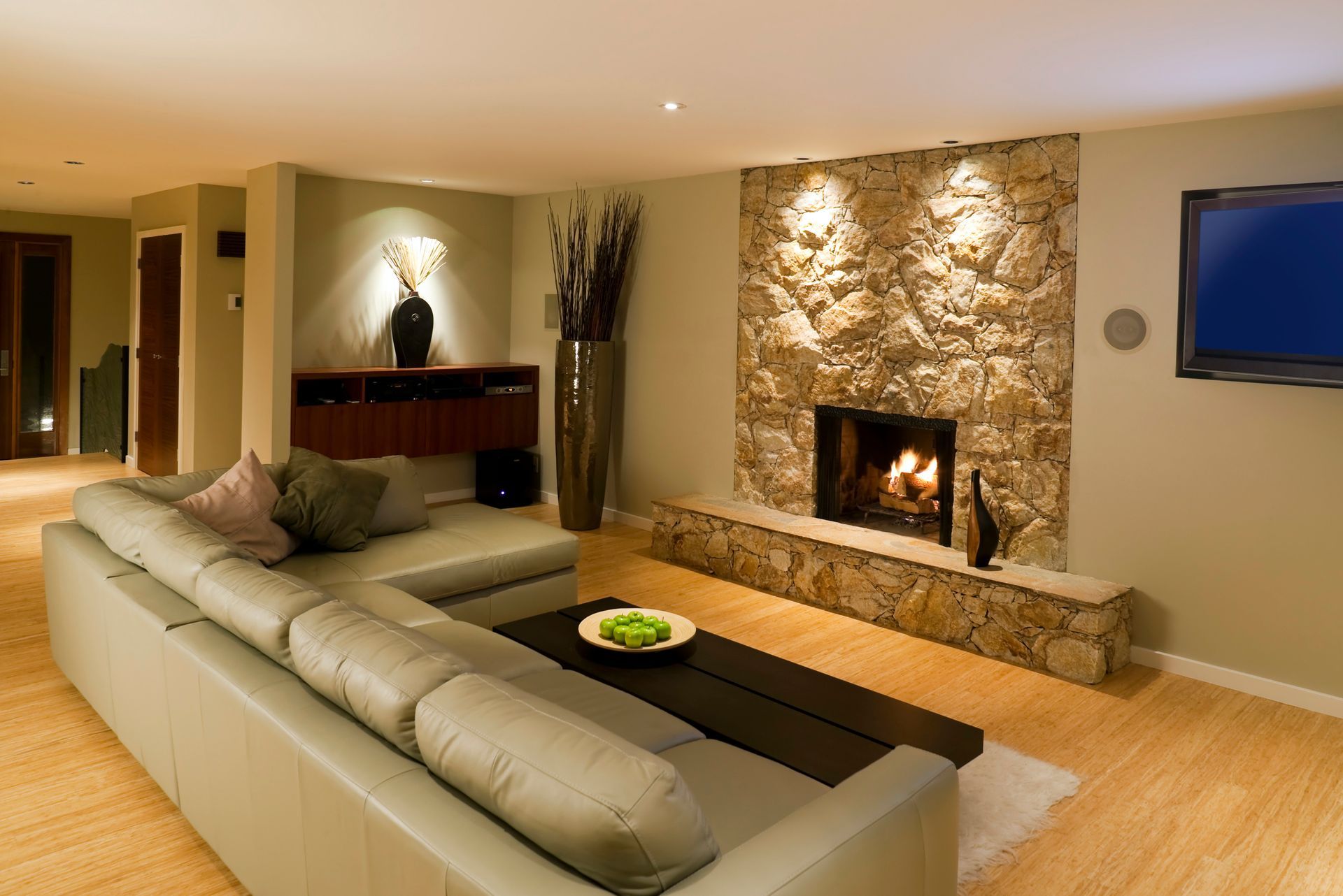 a living room with a fireplace and a flat screen tv