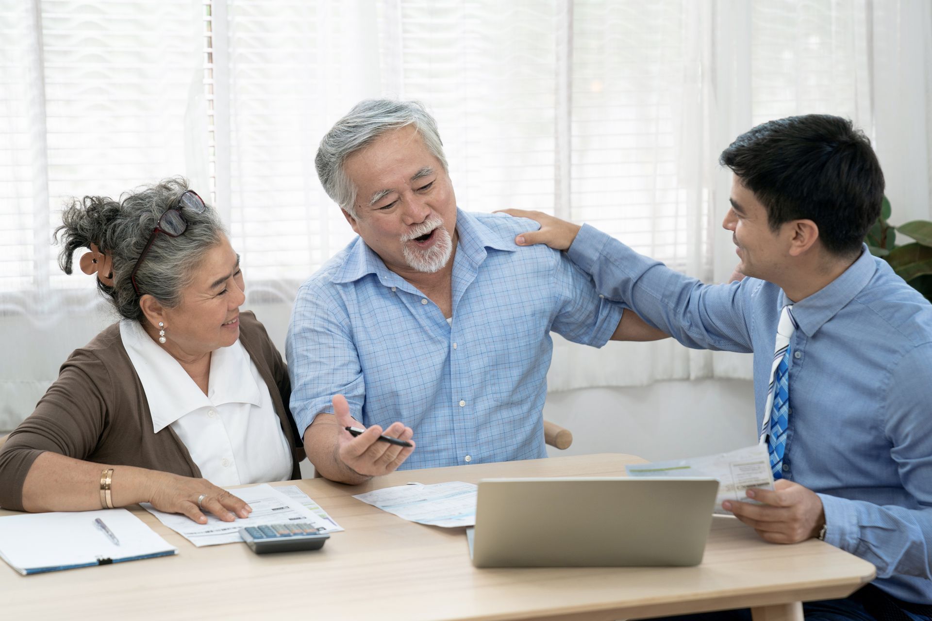 An insurance agent offers health insurance for Asian elderly couples, Finance staff present and close real estate sales.