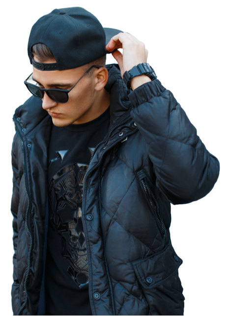Man in black puffer jacket, baseball cap, and sunglasses adjusts cap with his hand.