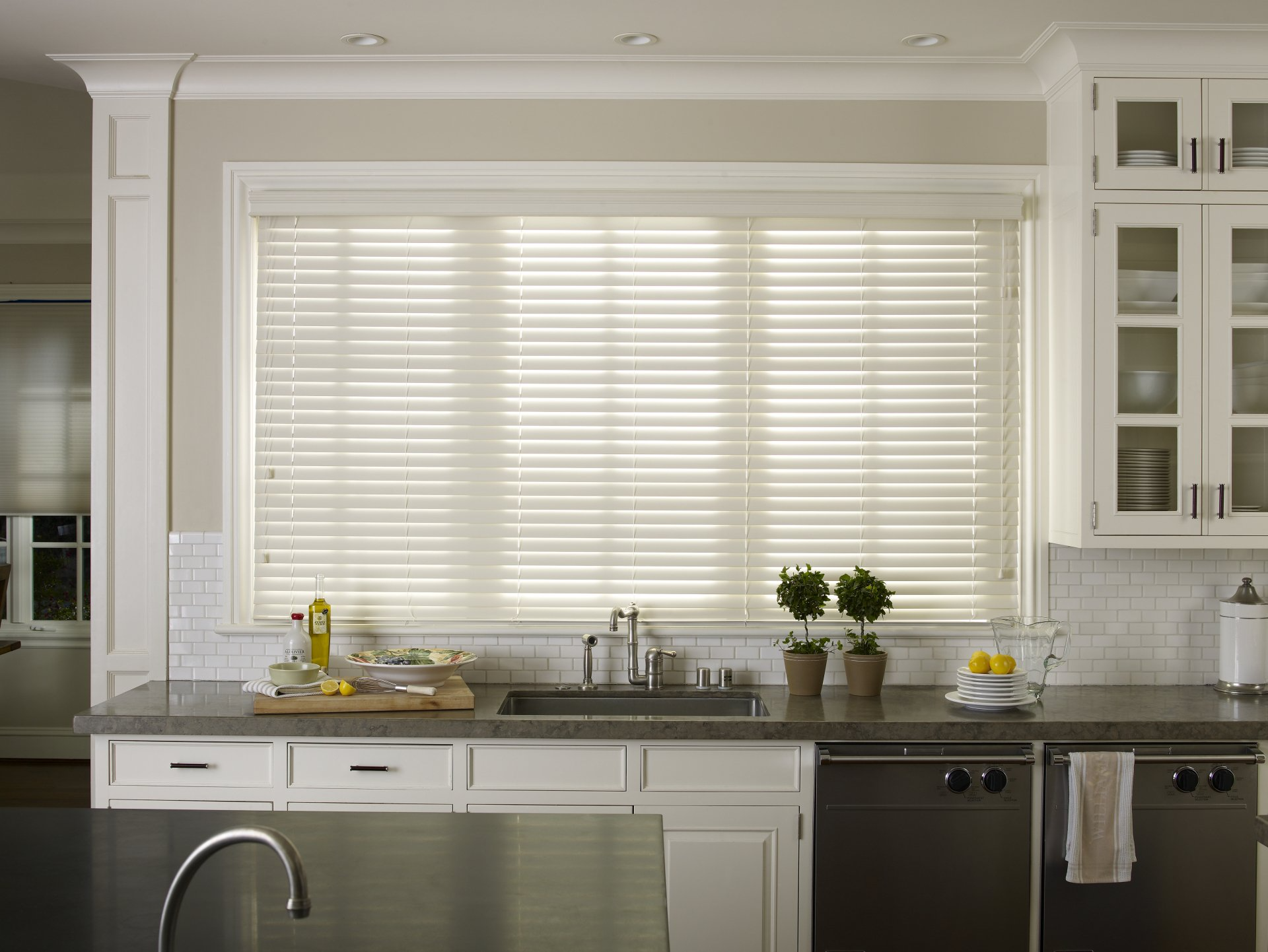 A kitchen with white cabinets and stainless steel appliances