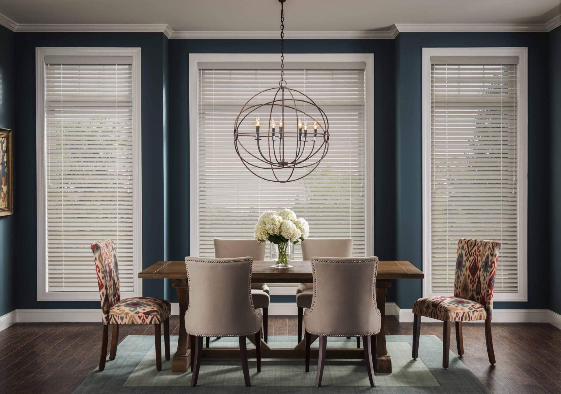 A dining room with a table and chairs and a chandelier.