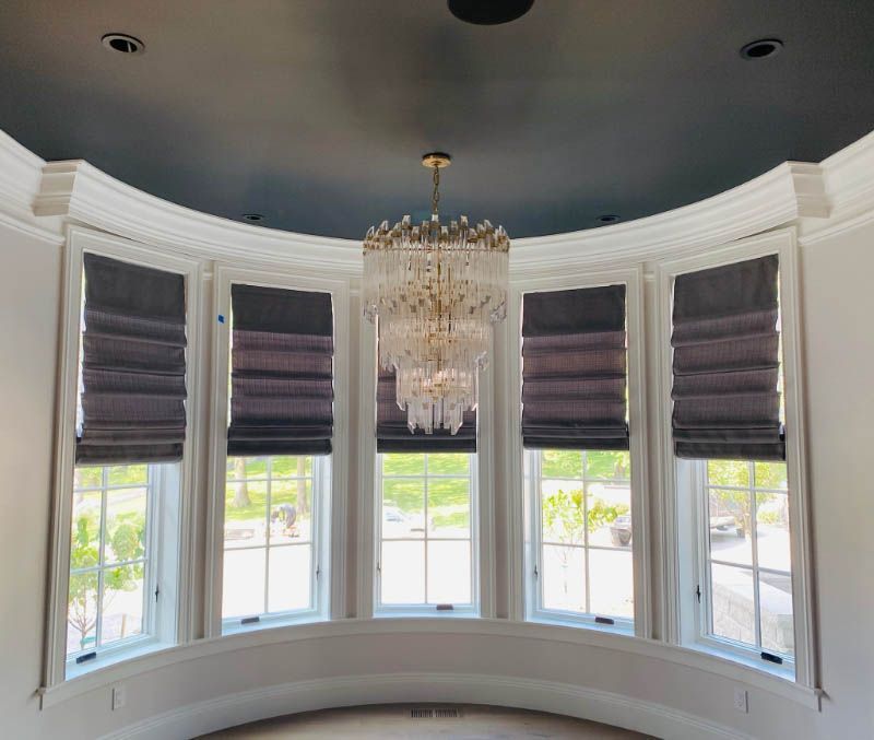There is a chandelier hanging from the ceiling in the room.