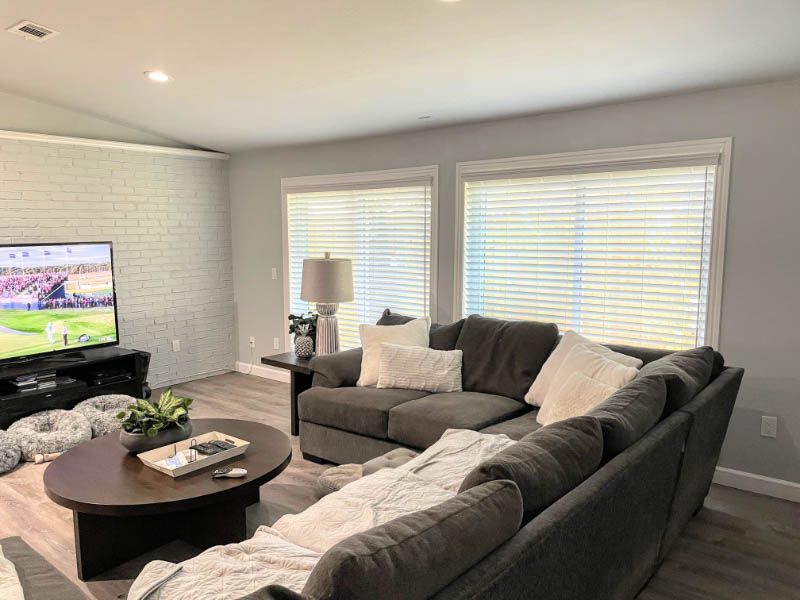 A living room with a couch , coffee table , and television.