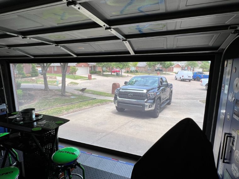 Exterior patio shades are being used for a home garage. 