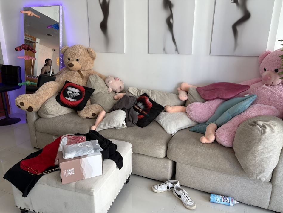 A living room filled with lots of stuffed animals including a teddy bear