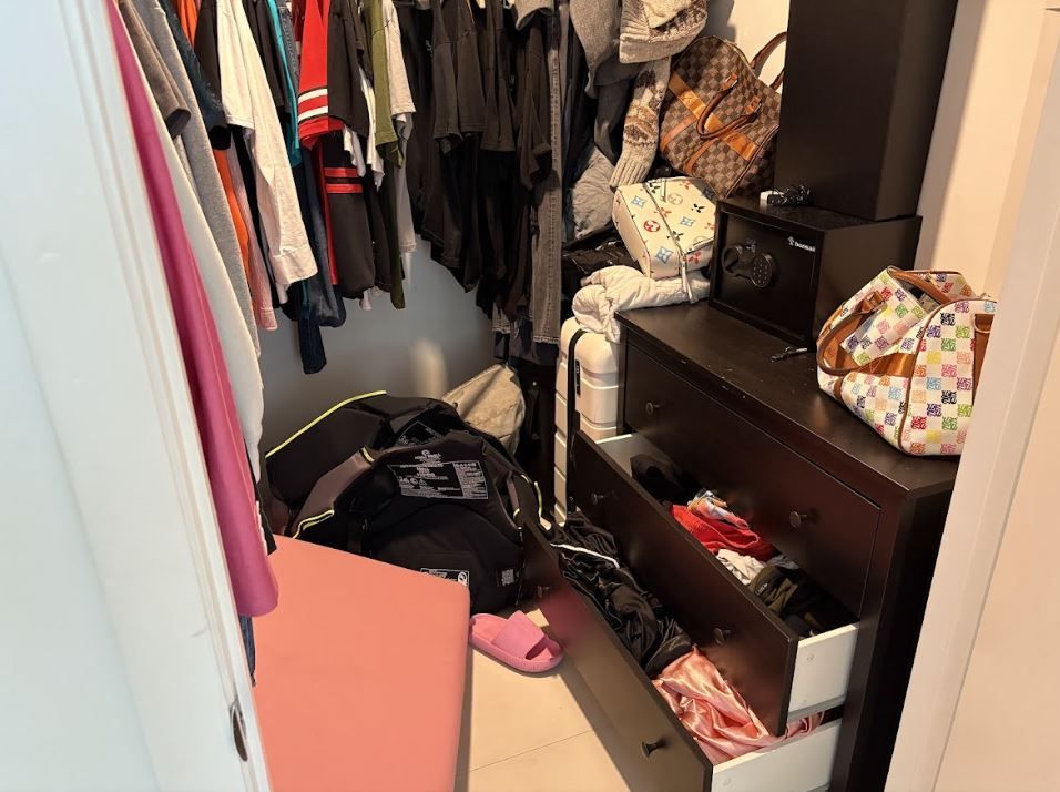 A closet with a lot of clothes and a dresser