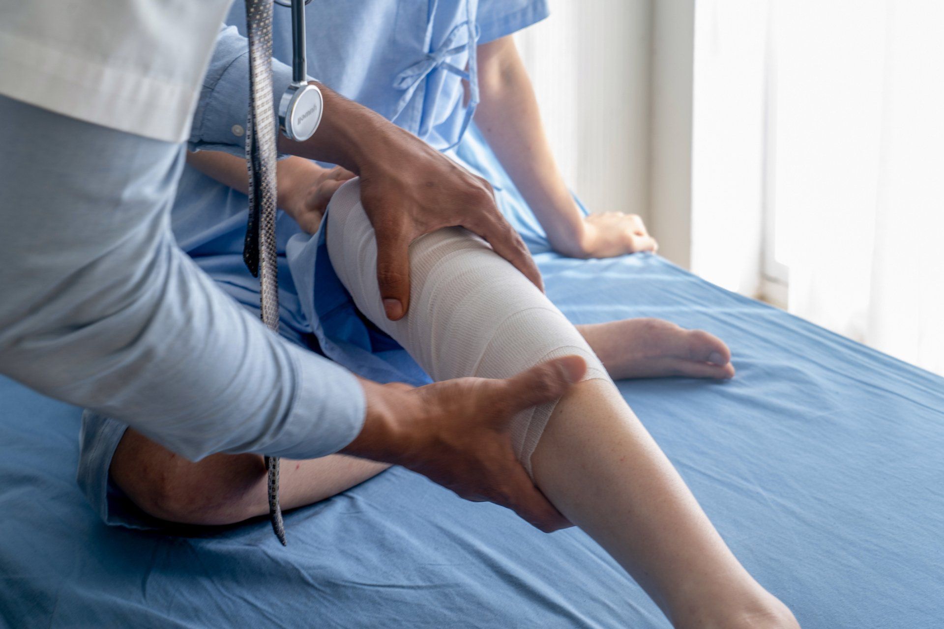 Touching Wrapped Knee - South Bend, IN - Kaurich Chiropractic & Wellness Center