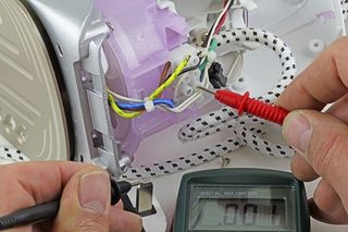 An Electrician Fault Finding an Electric Iron — Electrical Service in Swansea, NSW