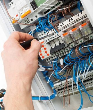 Electrician Fixing Switch Gear Cabinet — Electrical Service in Swansea, NSW