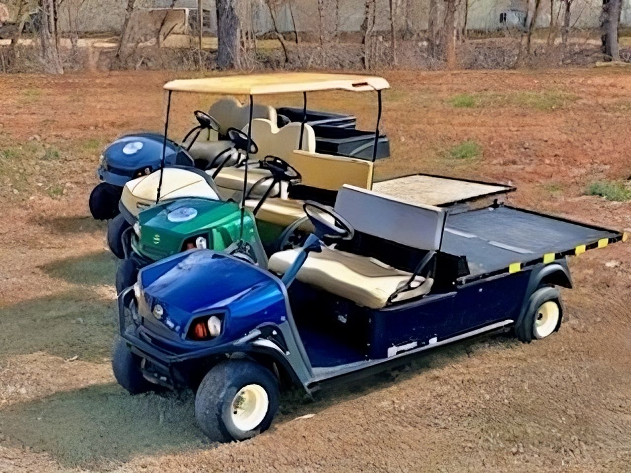 a group of golf carts are parked in a field
