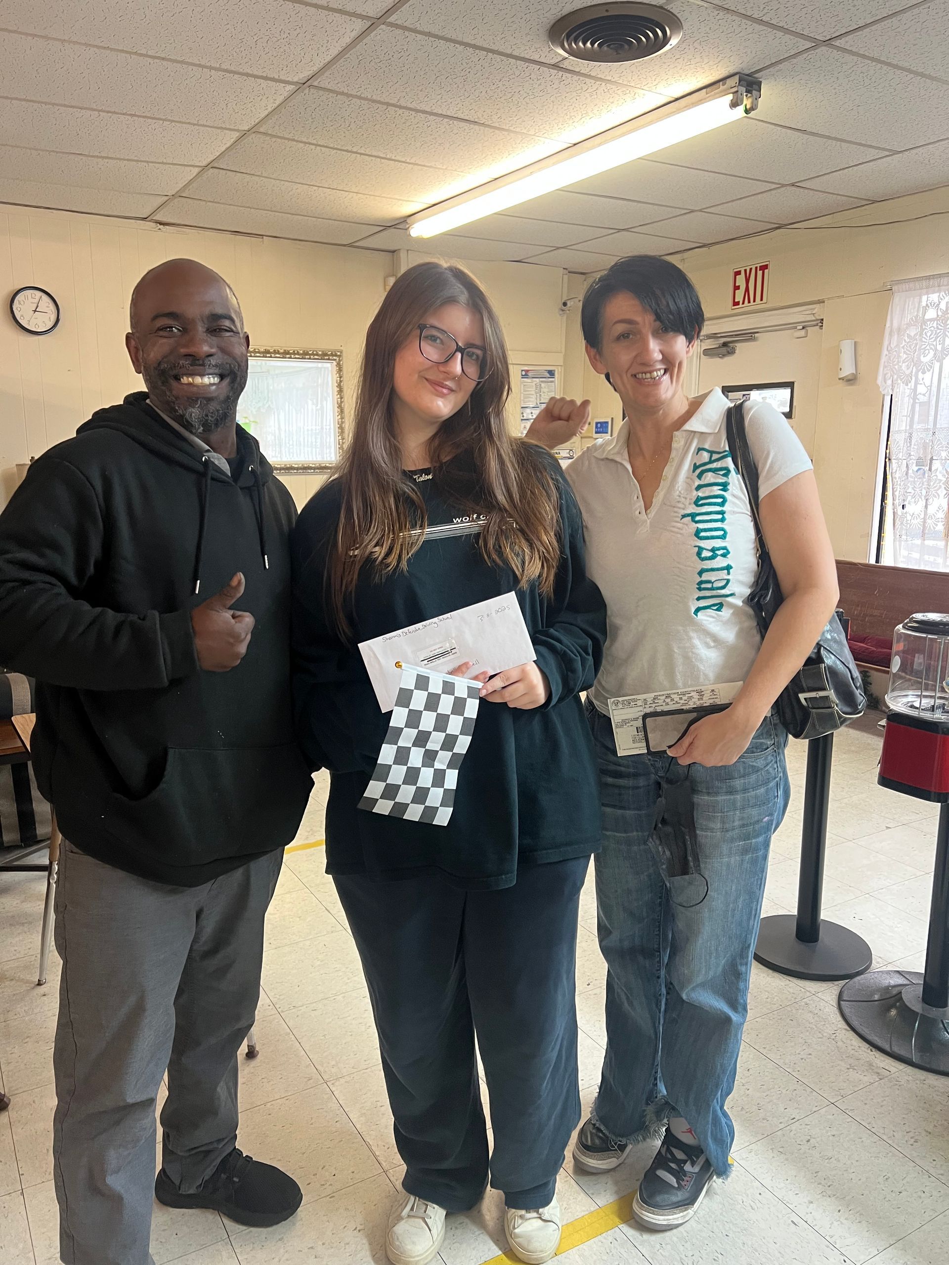 A group of people standing next to each other in a room.