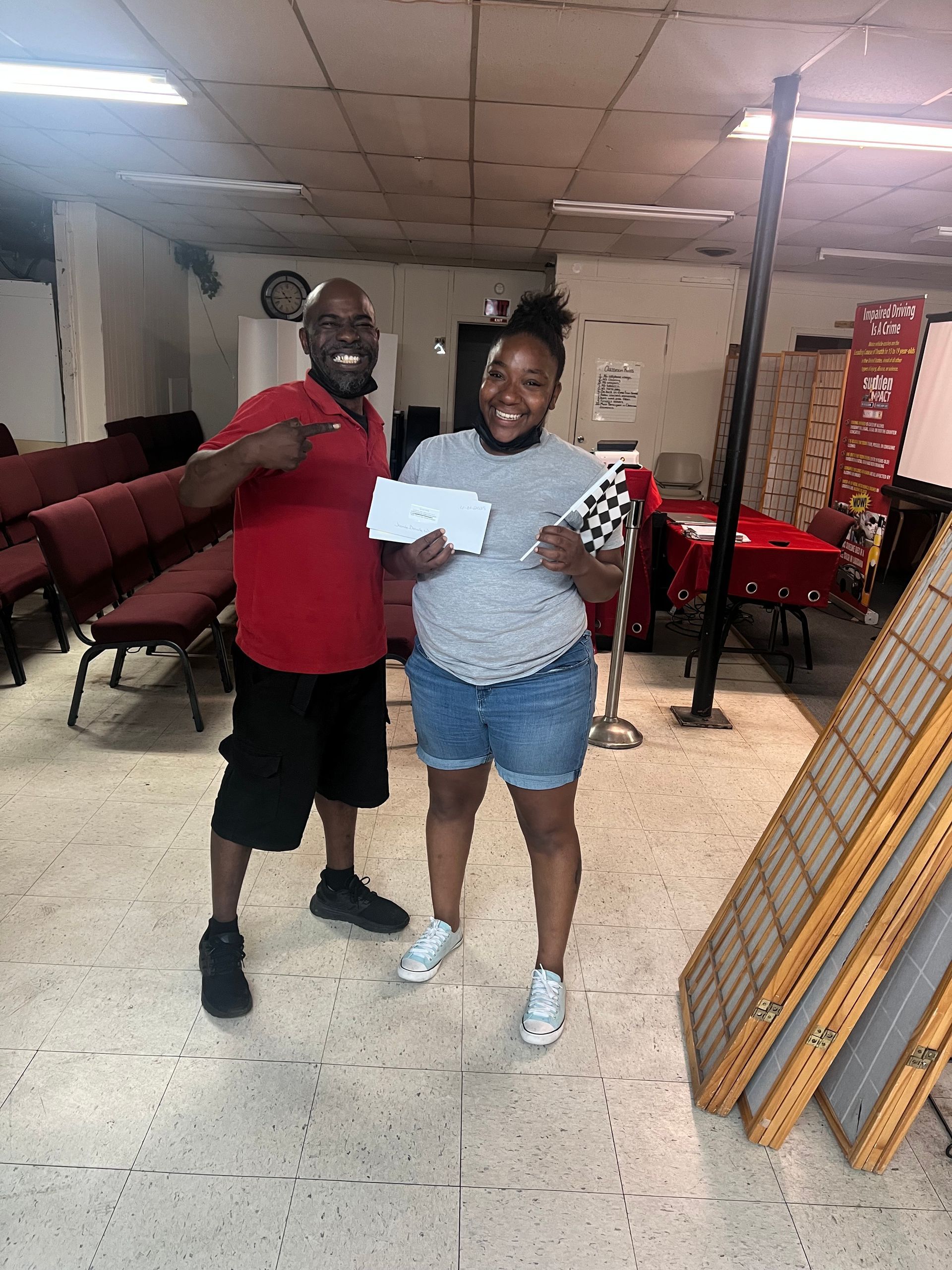 A man and a woman are standing next to each other in a room.