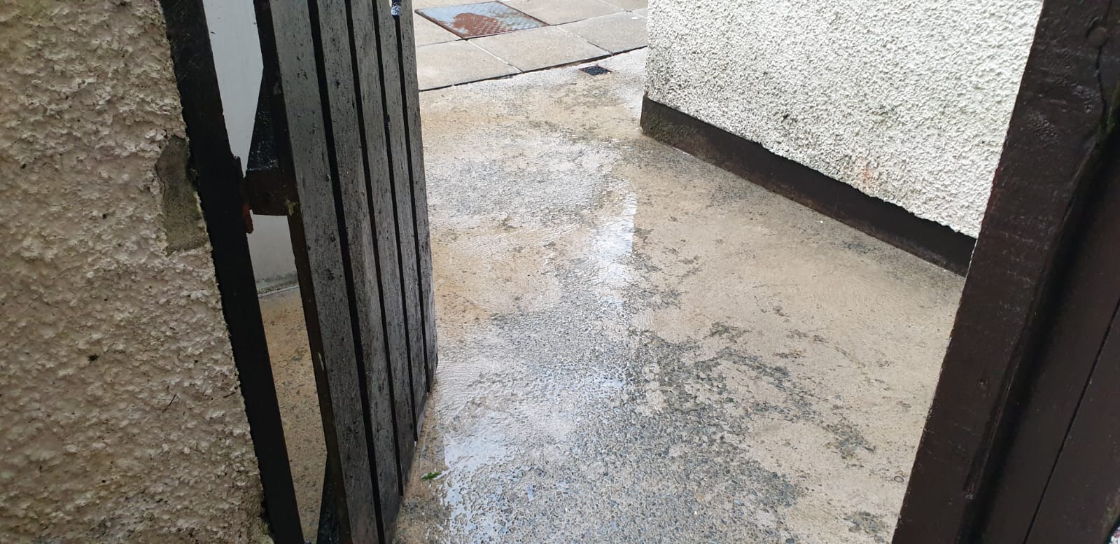 The door is open and there is a lot of snow on the ground.