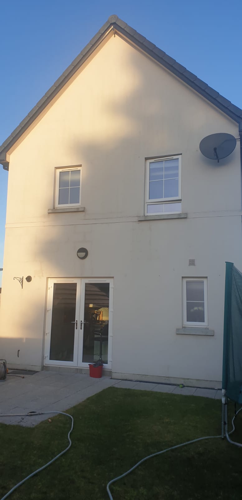 house with green algae cleaning