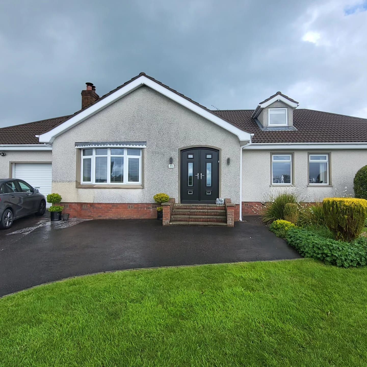 A house with a car parked in front of it