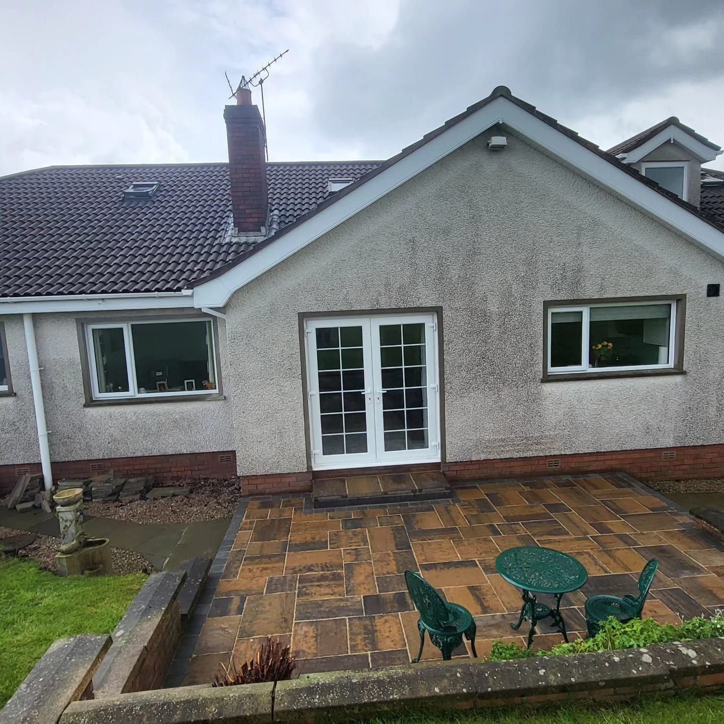 A house with a patio and chairs in front of it