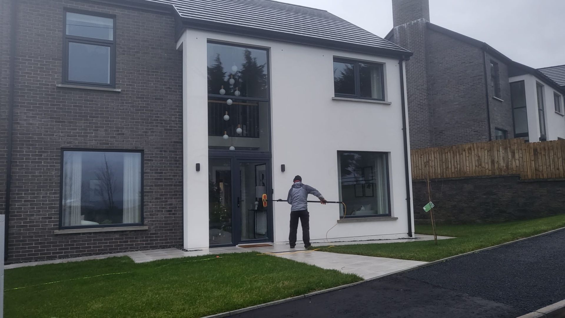 A man is cleaning the windows of a house.