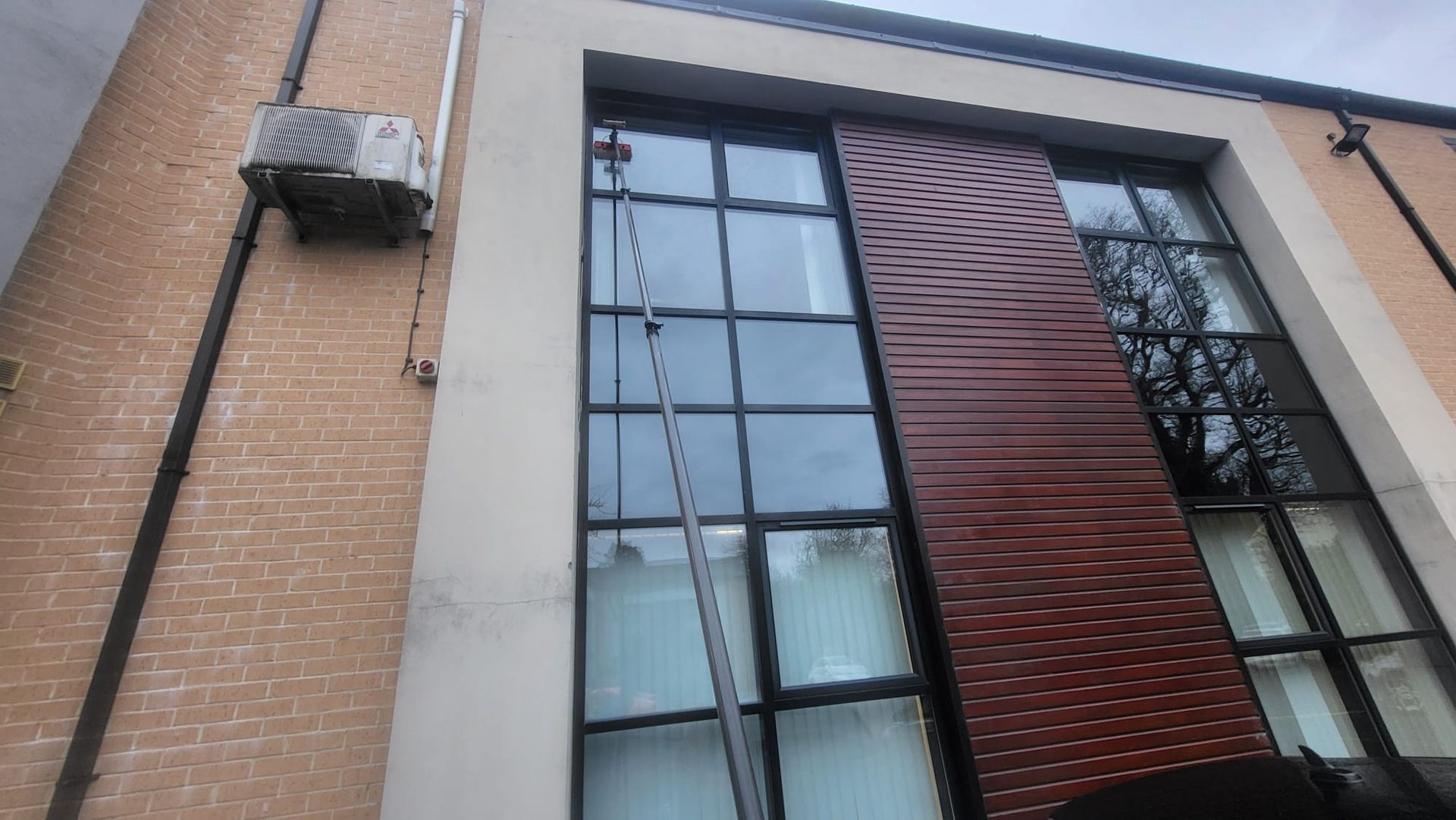 A large building with a ladder hanging from the side of it.