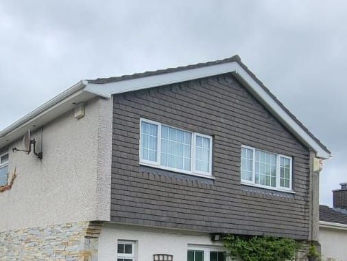 A house with a roof that has a lot of windows on it.