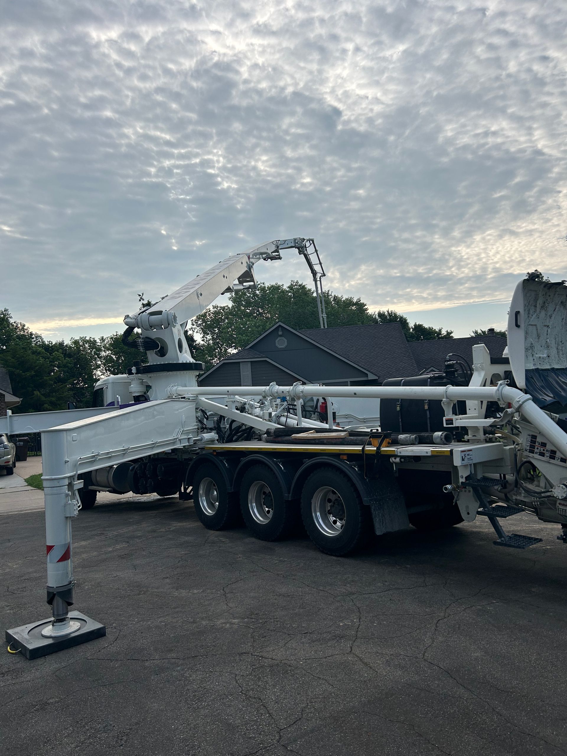 A concrete pump truck is parked in a parking lot.