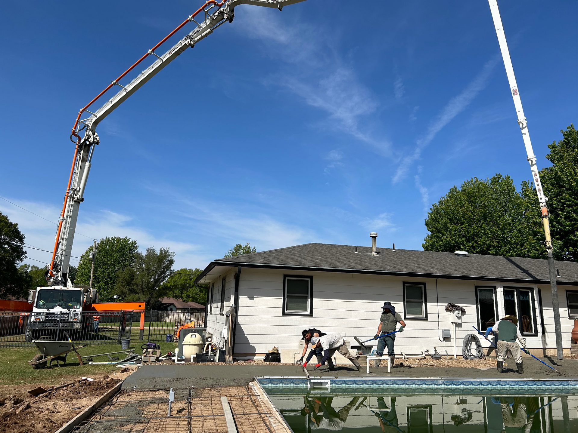 a concrete pump is being used to pour concrete into a pool