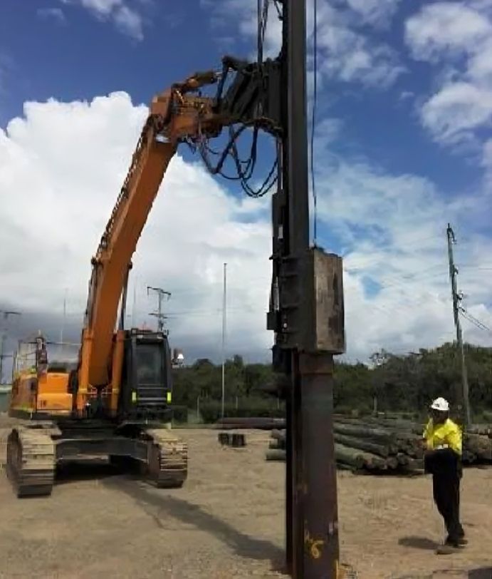 Pile driving equipment securing structural piles into the ground for deep foundations.