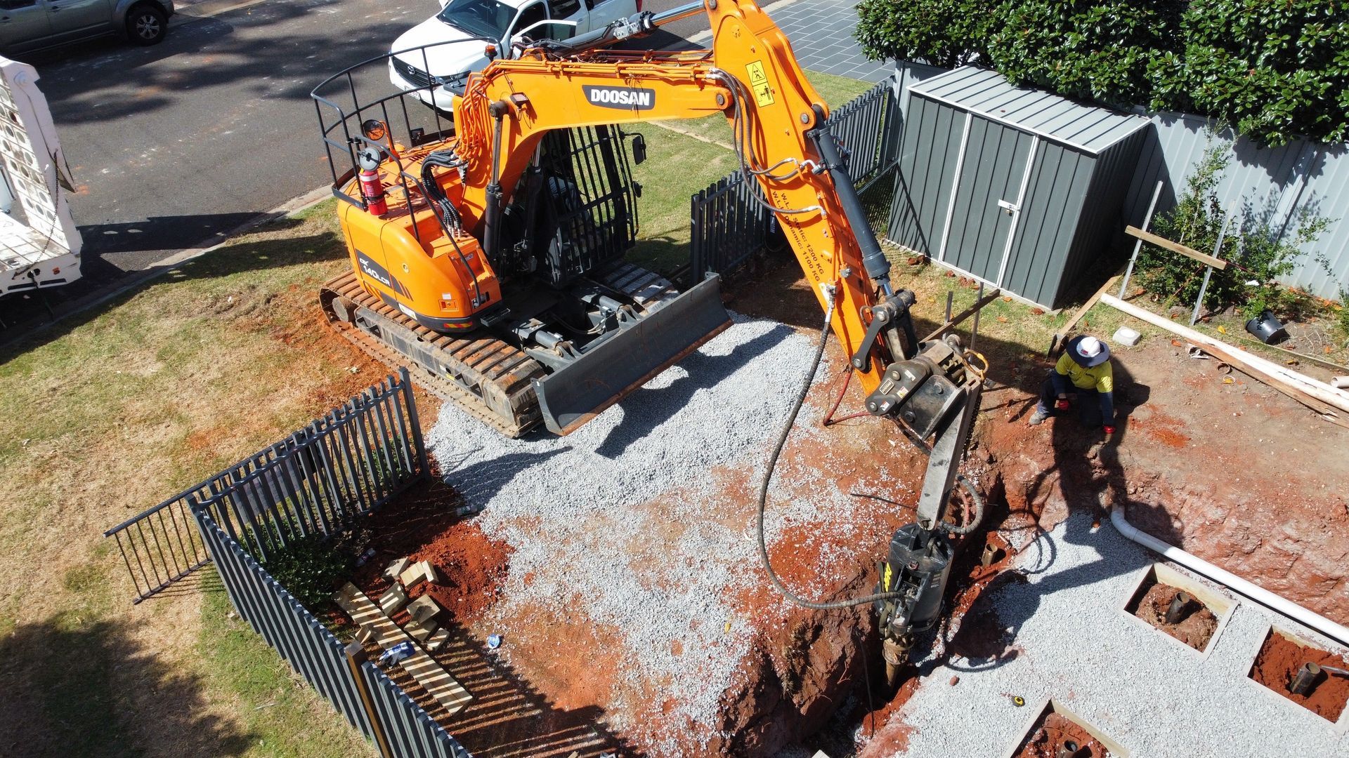 An Aerial View Of An Excavator Digging A Hole In The Ground — Southeast QLD — East Coast Group of Companies
