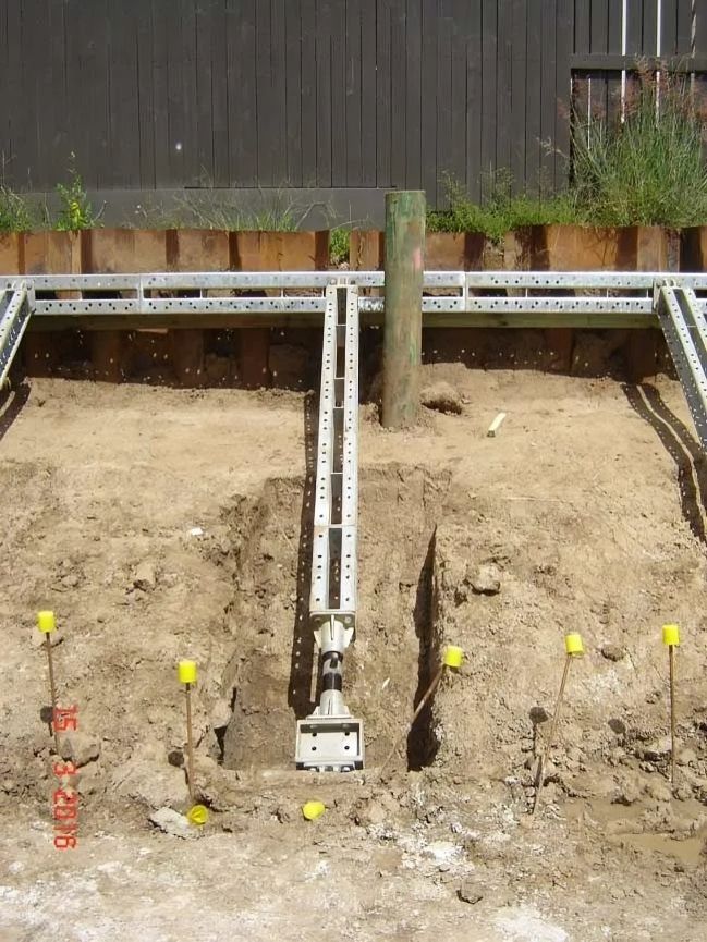 Retention piling and anchoring works during foundation excavation.