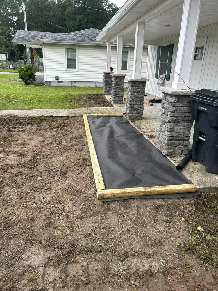 A walkway is being built in front of a house.