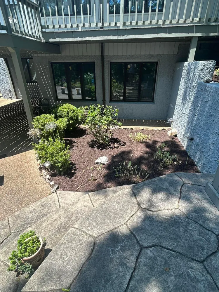 An aerial view of a garden in front of a house.