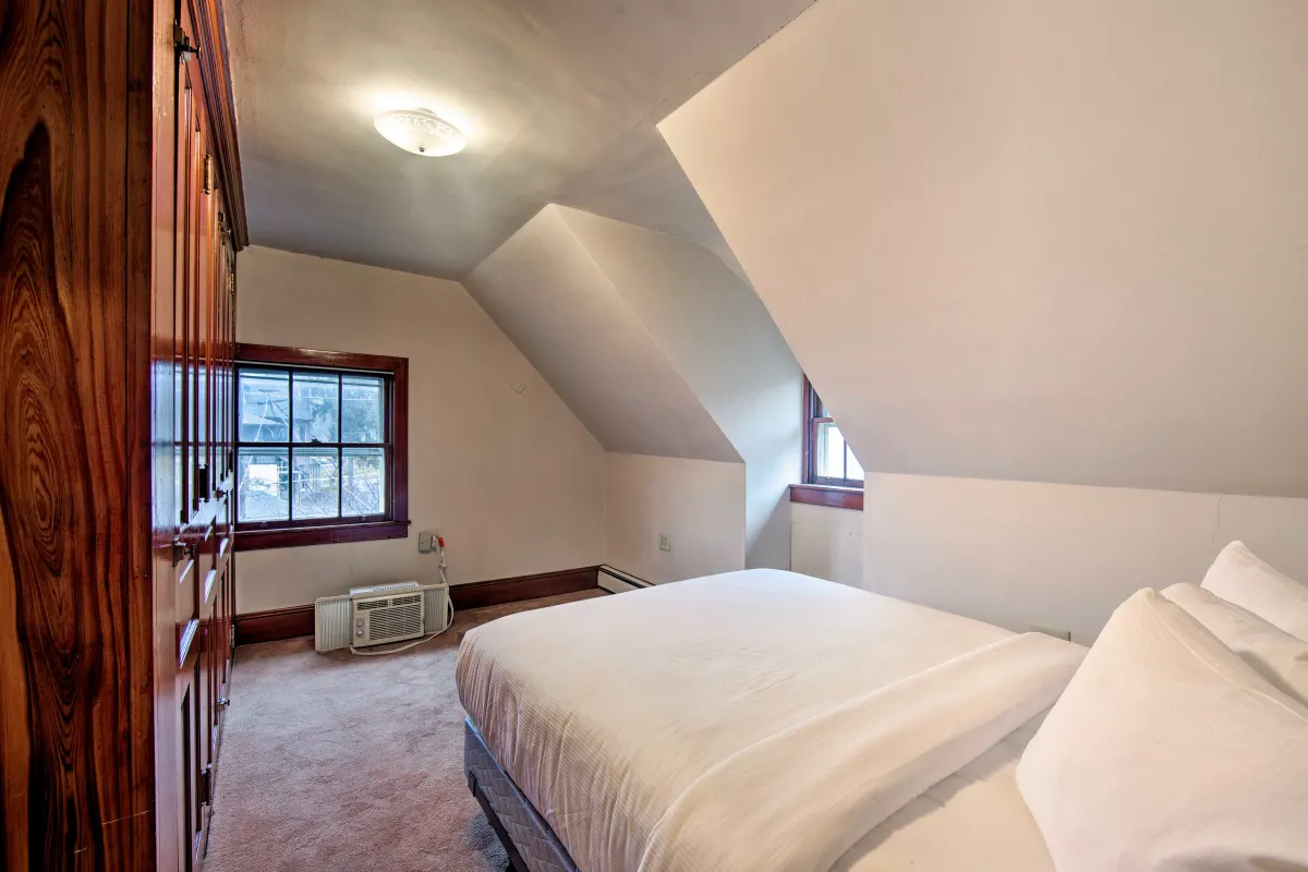 A bedroom with a king size bed and a window