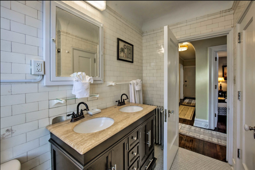 A bathroom with two sinks and a mirror