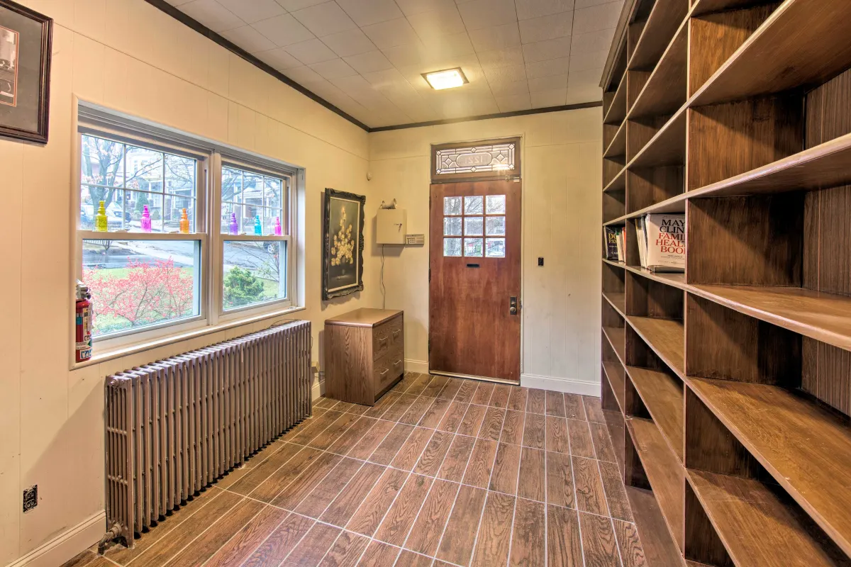 A room with a lot of shelves and a door.