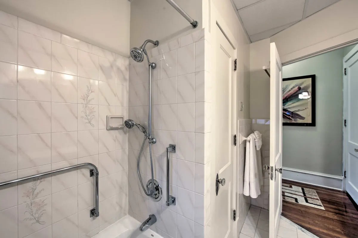 A bathroom with a walk in shower and a toilet.