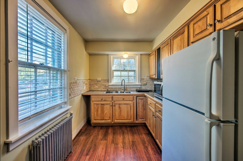 A kitchen with wooden cabinets and a white refrigerator