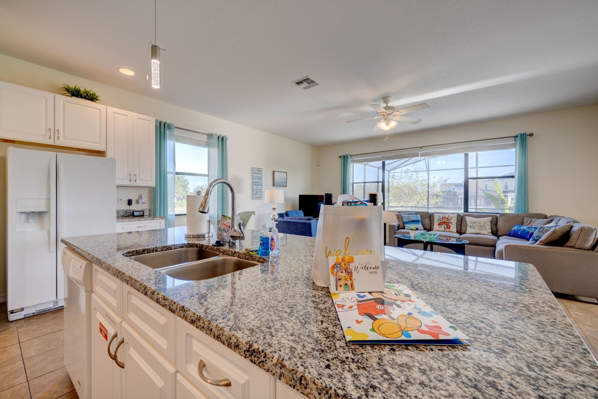A kitchen with a granite counter top and a sink.
